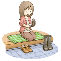 靴を座って磨いている女性のイラスト